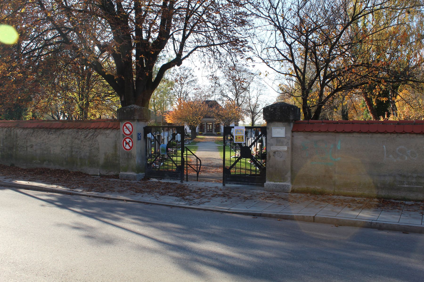 Old main gate in the cemetery wall beside the road at Aubing Cemetery